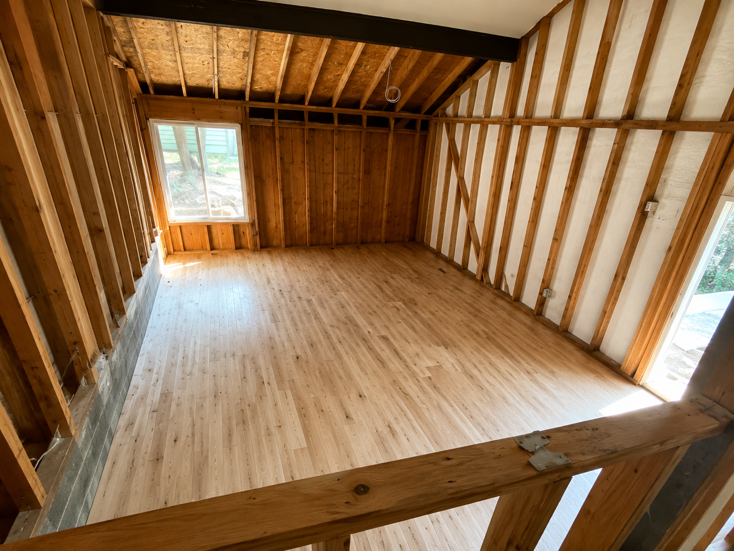 Light wood floor in an open framed loft