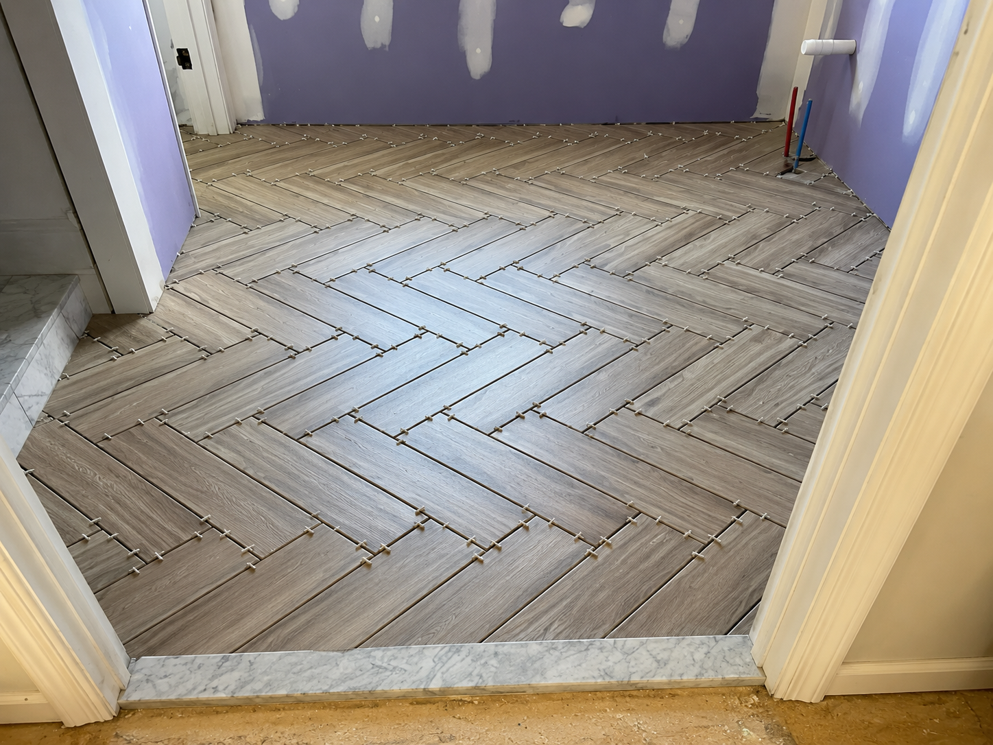 Herringbone tile entryway installation