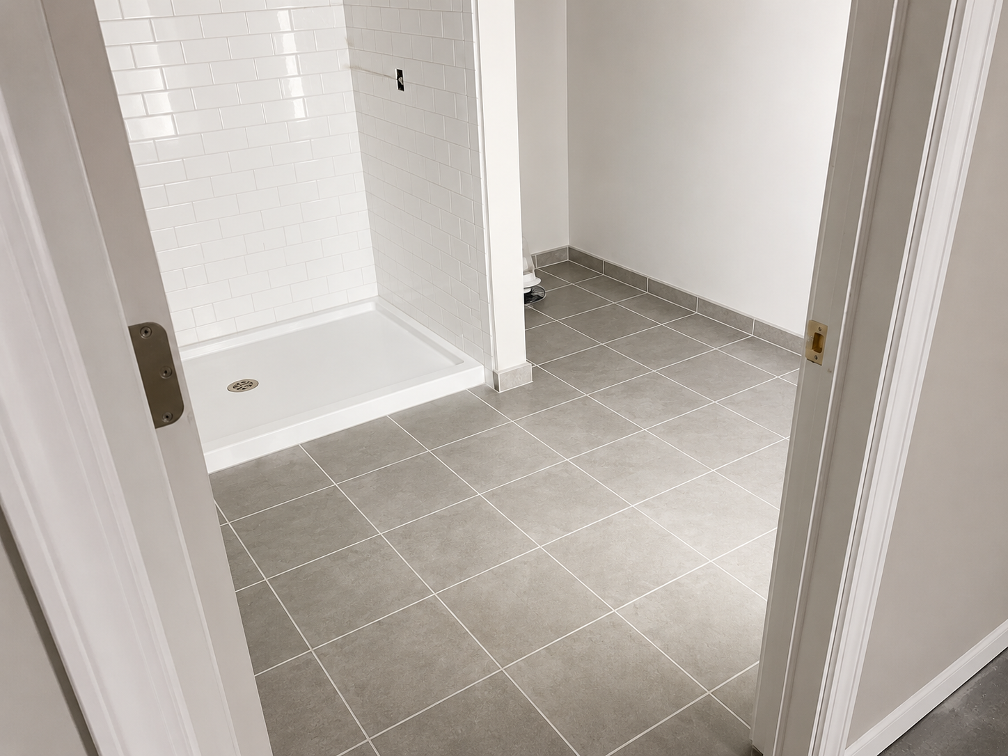 White subway tile shower with diagonal floor tile