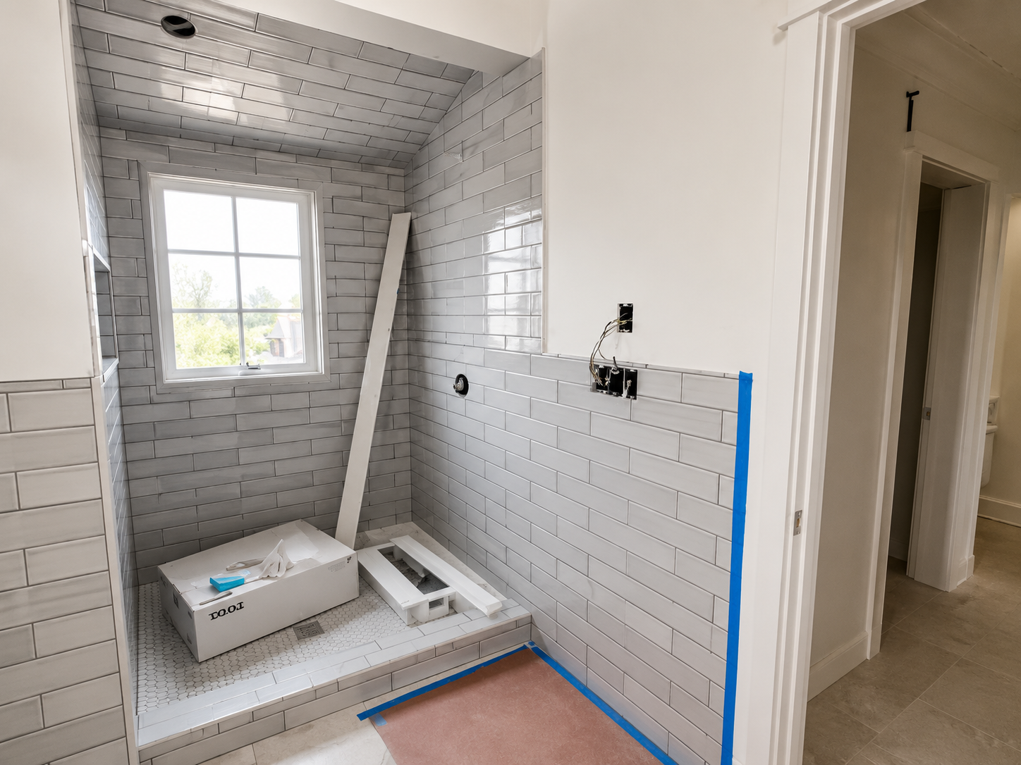 Gray tile shower with window, in progress