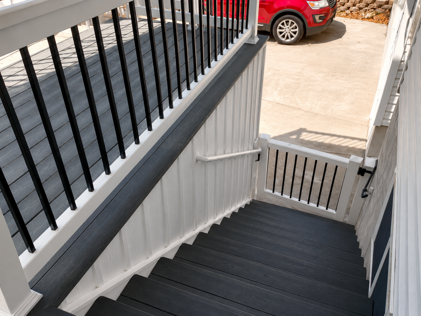Composite deck stairs with black aluminum railing
