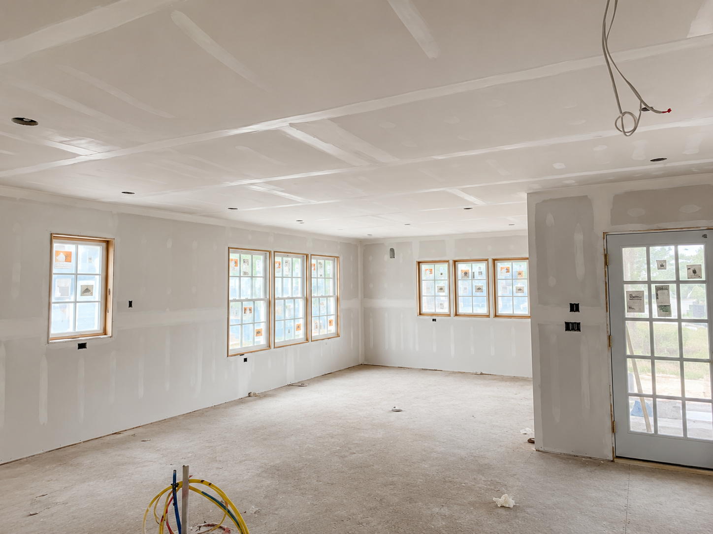 Freshly drywalled open-concept living room interior