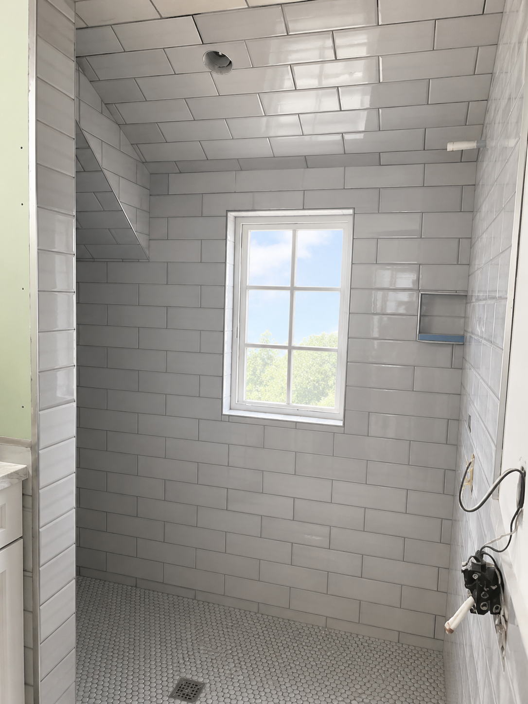 Gray subway tile shower with window