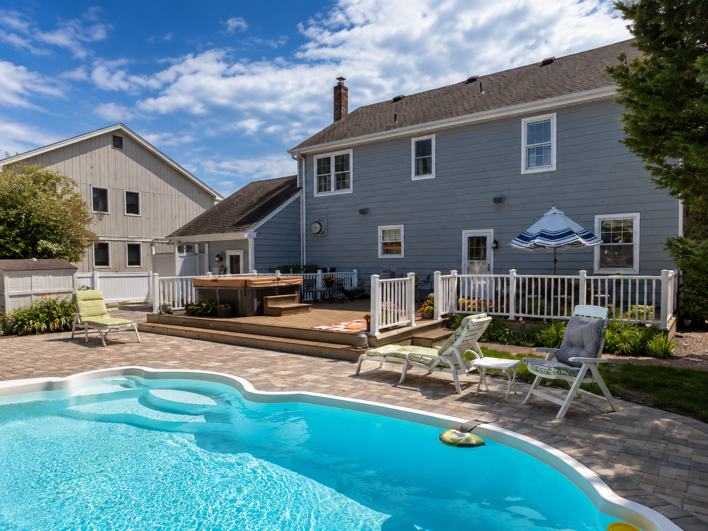Inground pool with paver patio and full backyard