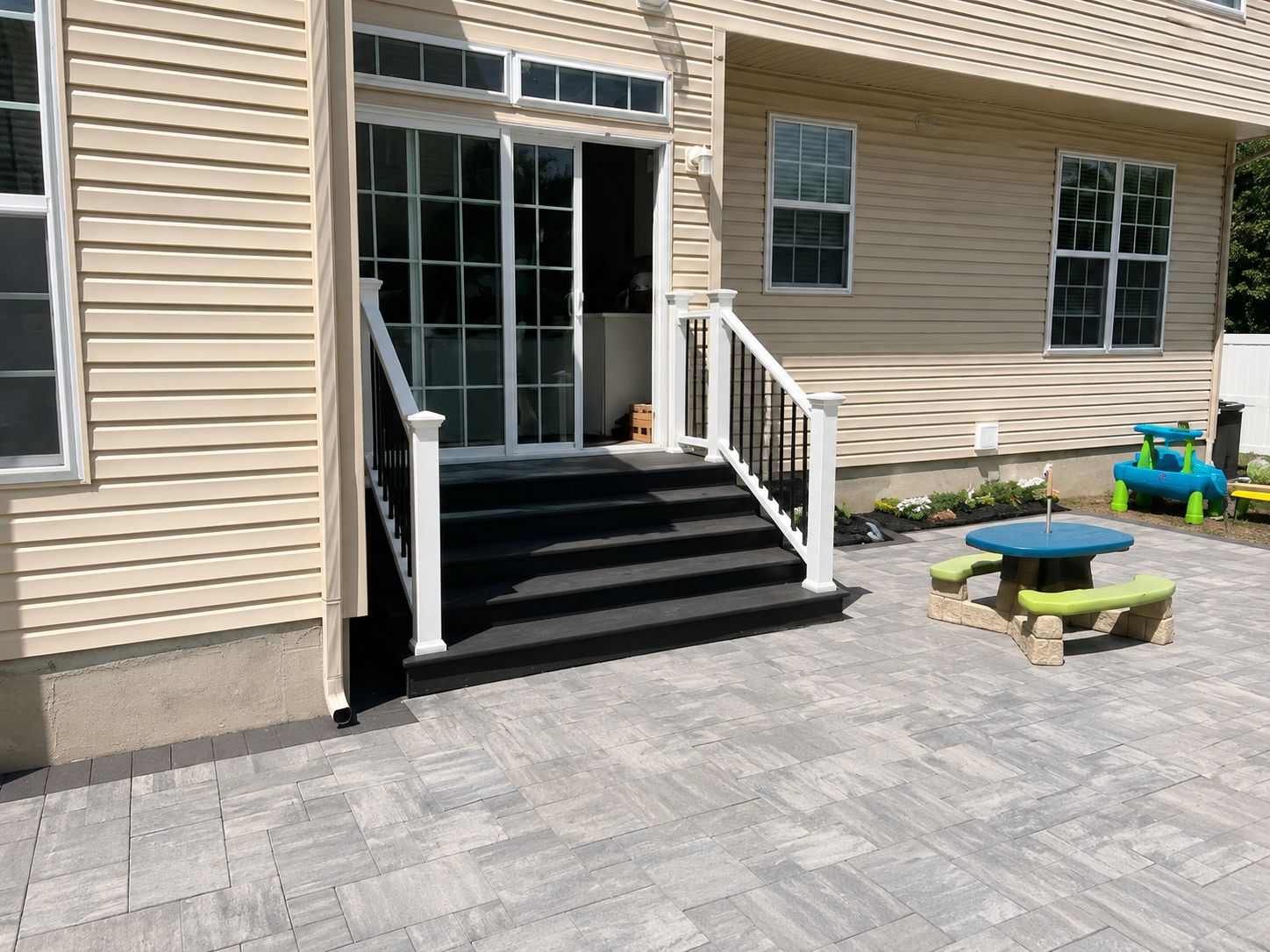 Paver patio with black composite steps